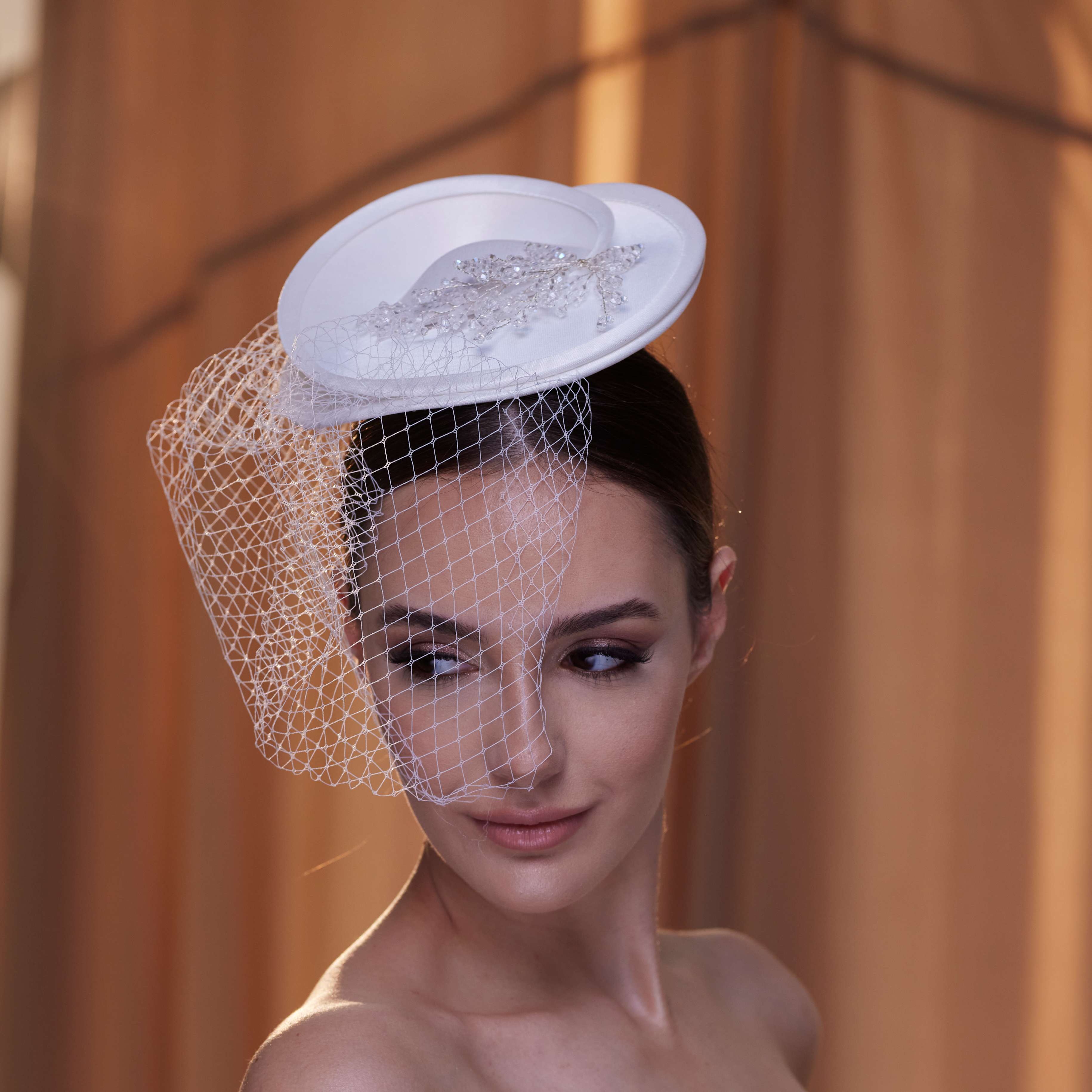 Elegant Bridal Fascinator with Beaded Details and Birdcage Veil